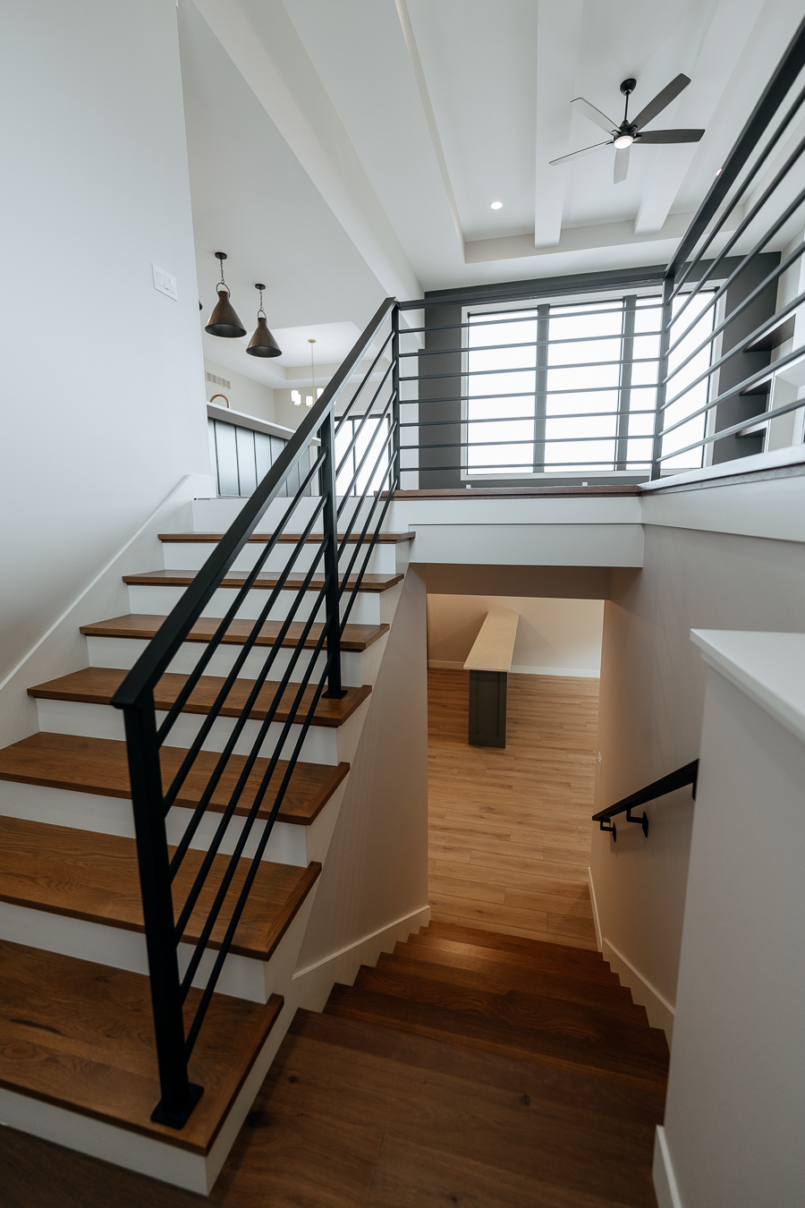 Open staircase with wood treads and black metal railings