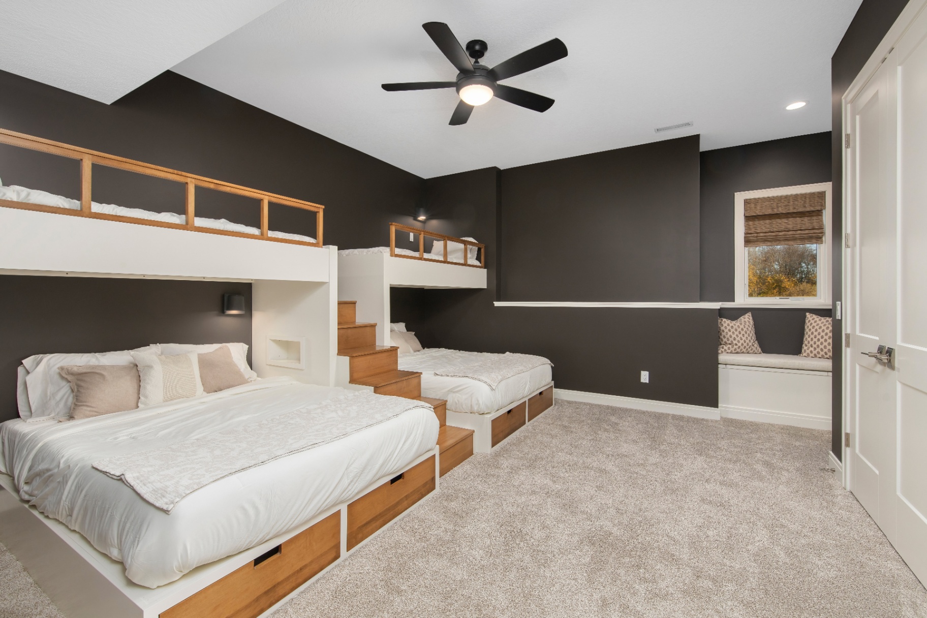 Custom bunk room with built-in beds and moody accent walls