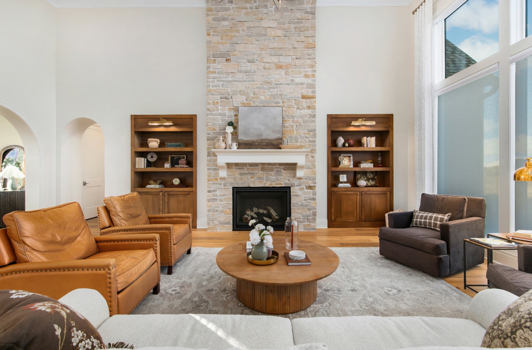 Two-story great room with floor-to-ceiling stone fireplace